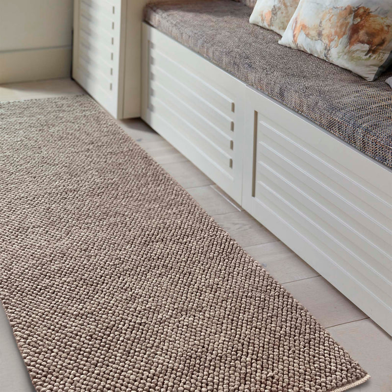 La Playa Rustic Brown Runner with a textured design, styled in a entryway.