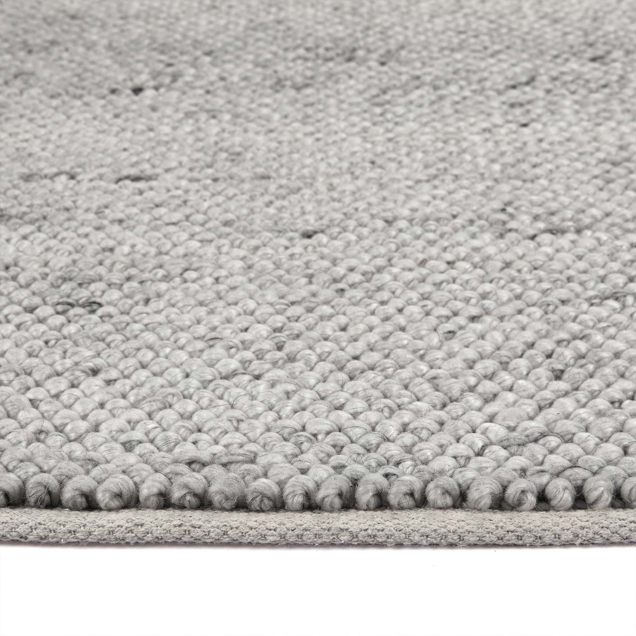 Close up of La Playa Silver Grey Rug showing pile height and its textured design.