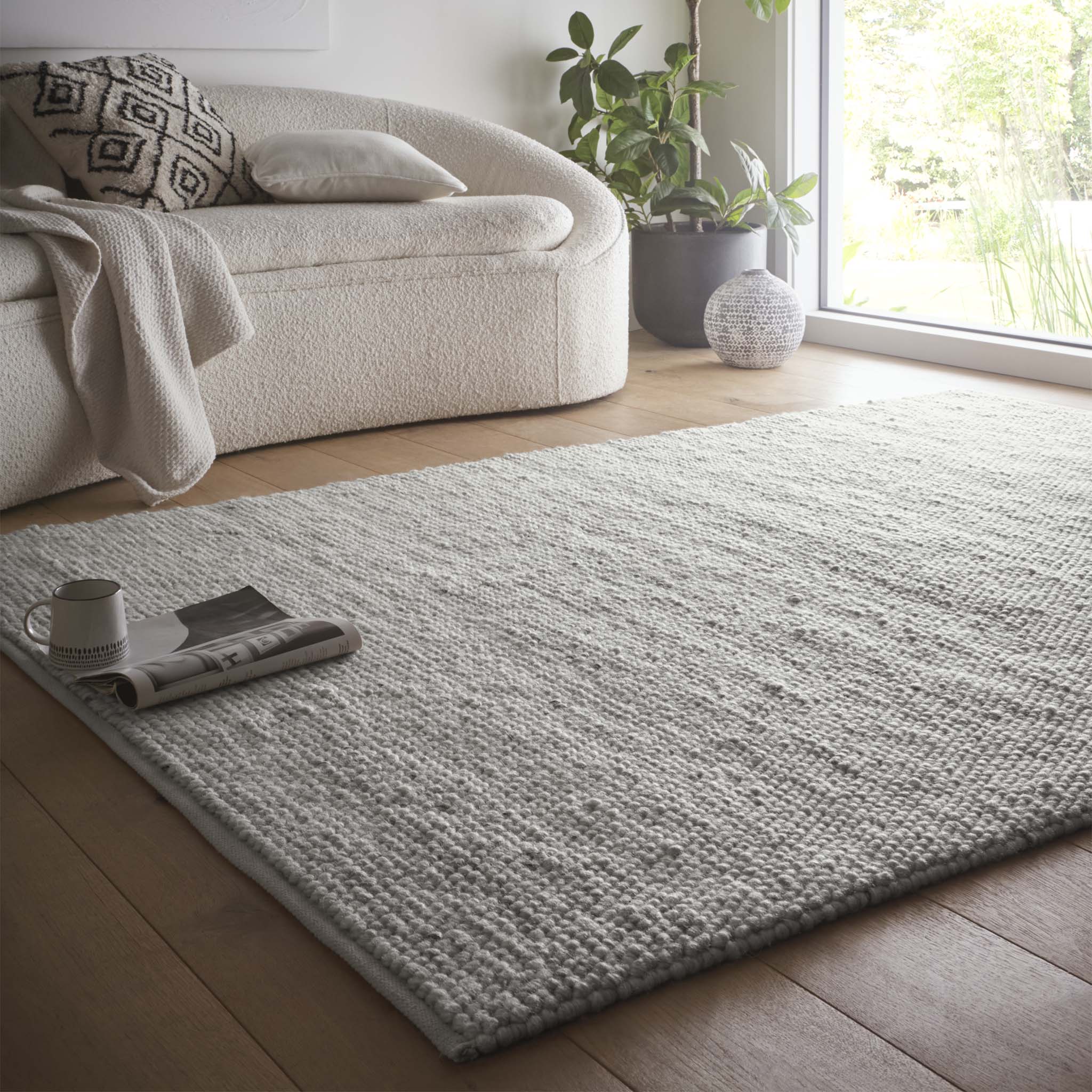La Playa Silver Grey Rug with a textured design, styled in a living room.