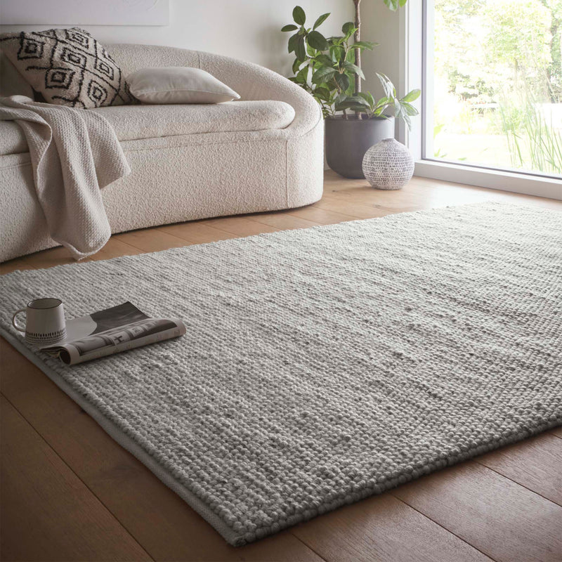 La Playa Silver Grey Rug with a textured design, styled in a living room.