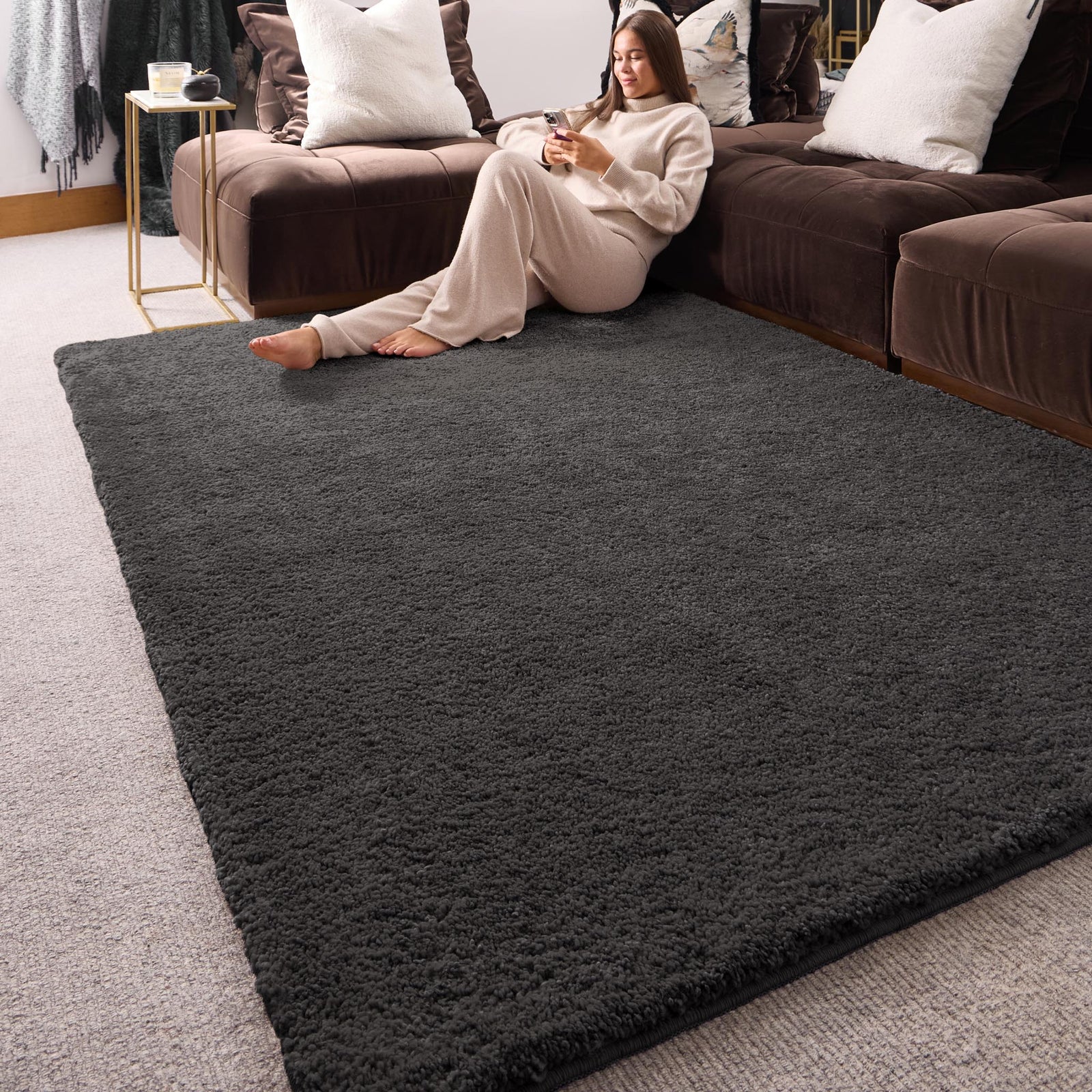 My Lux Charcoal Grey Washable Rug in a solid dark grey colour, styled in a living room.