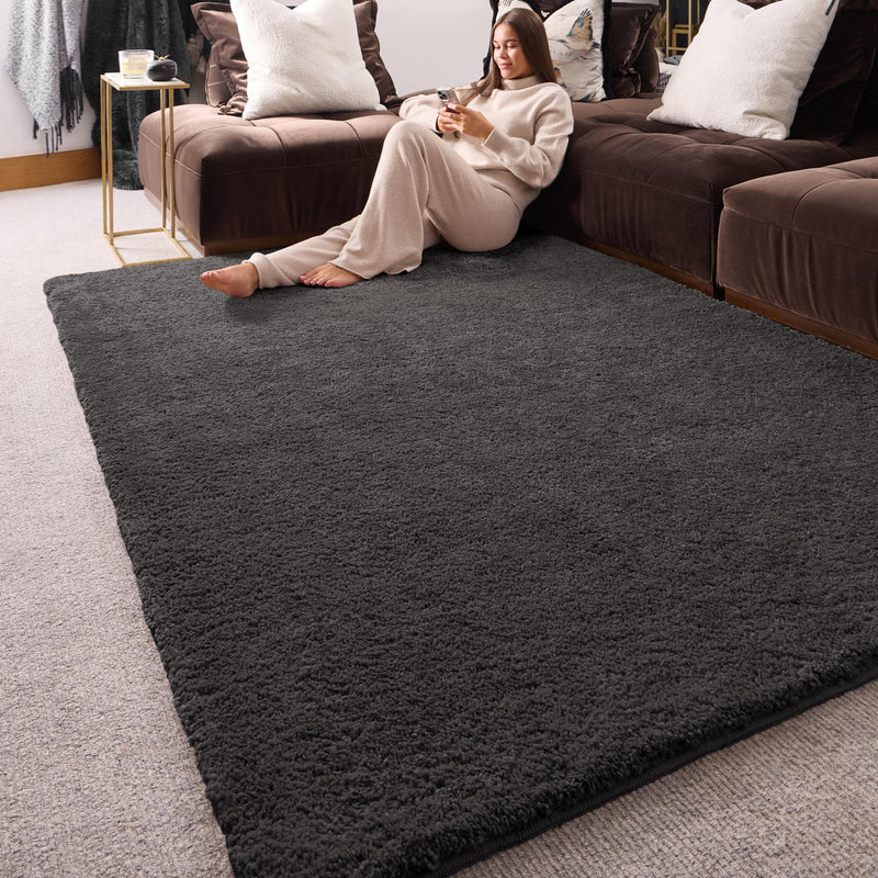 My Lux Charcoal Grey Washable Rug in a solid dark grey colour, styled in a living room.
