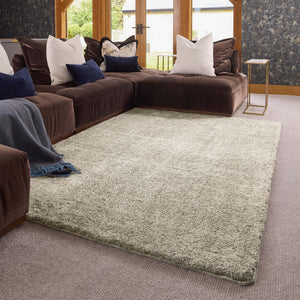 Luxe Cream Washable Rug with a shaggy pile in cream, styled in a living room.