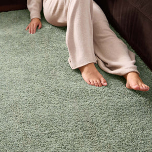 Close-up of Luxe Green Rug with a shaggy pile in green.
