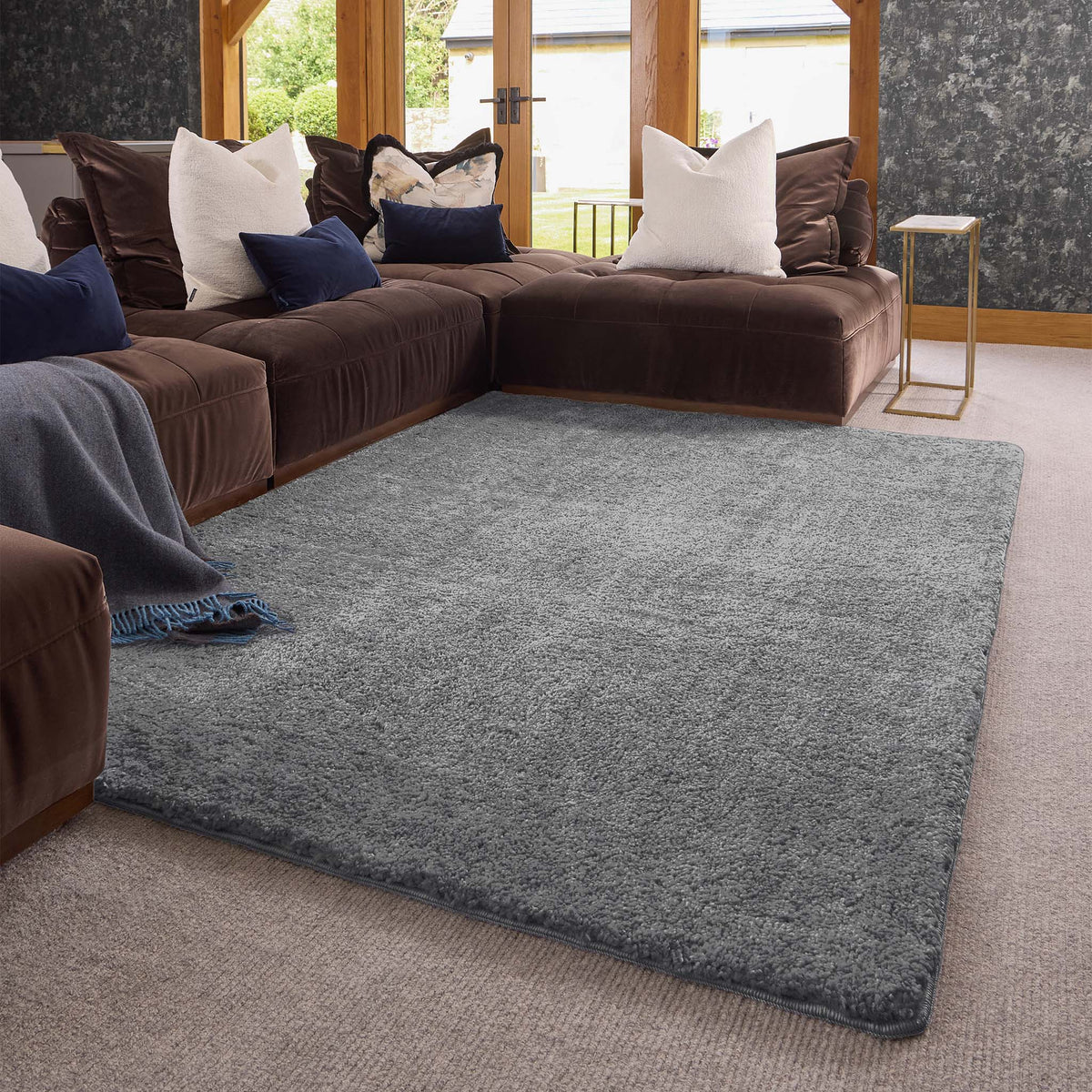 Luxe Grey Rug with a shaggy grey pile, styled in a living room.
