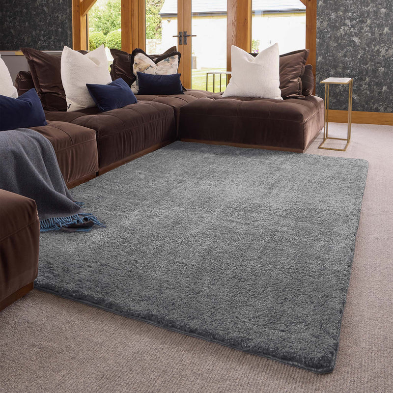 Luxe Grey Rug with a shaggy grey pile, styled in a living room.