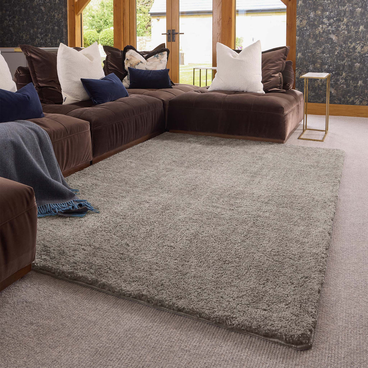 Luxe Stone Rug with a shaggy grey pile, styled in a living room. 