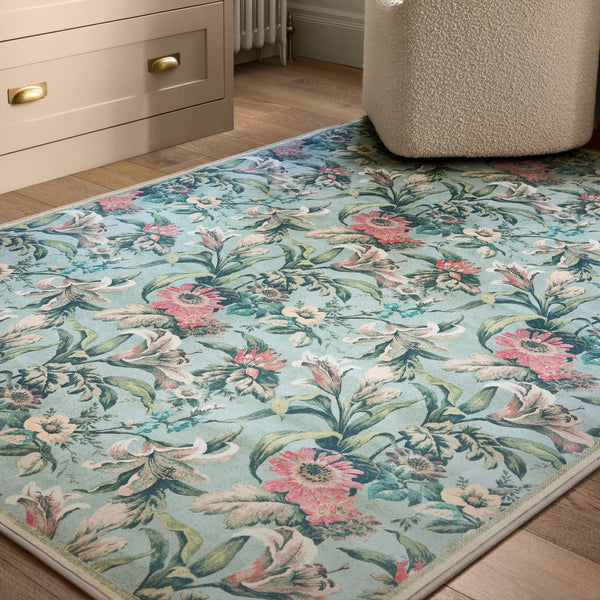 Lys Blue Eco-Washable Rug with a floral design, styled on wooden flooring. 