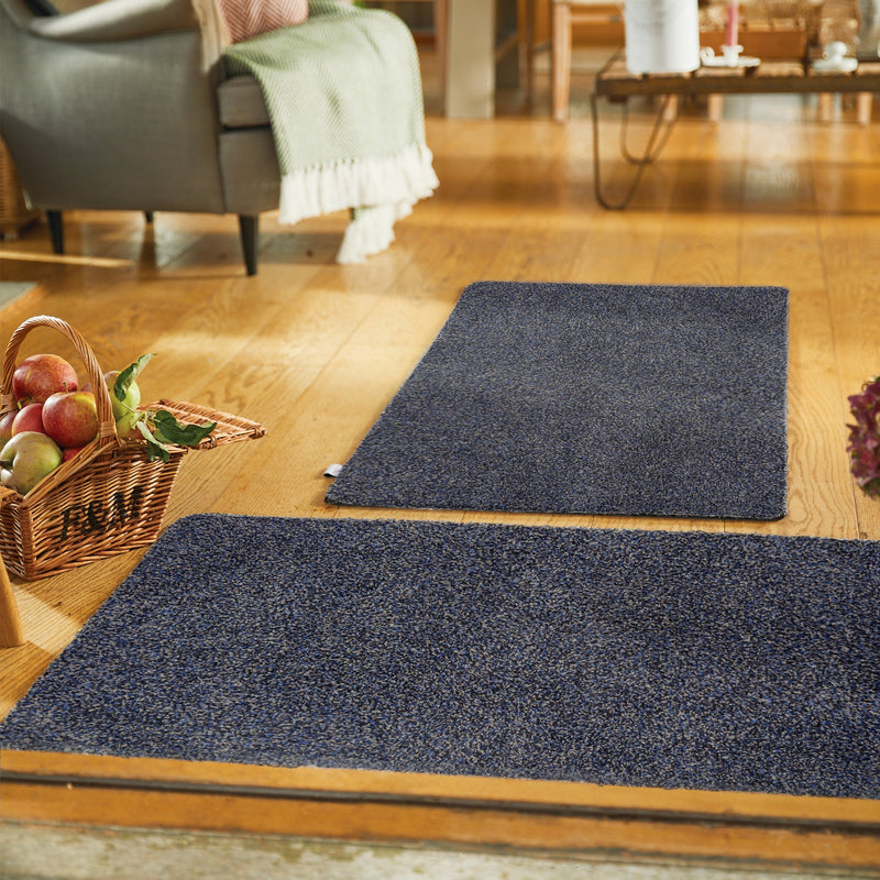 Midnight Blue Washable Doormat in a blue fleck pattern, styled in a entryway.