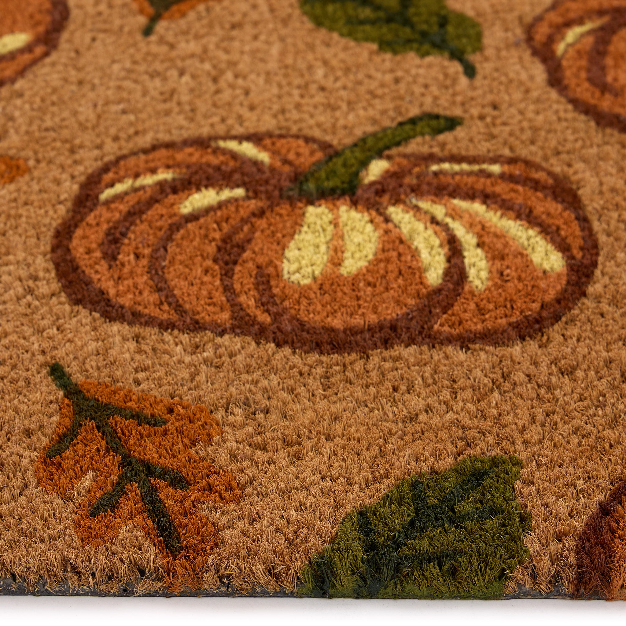 Discover the Multi Pumpkins Coir Doormat- a coir doormat with pumpkins and green/orange leaves. 