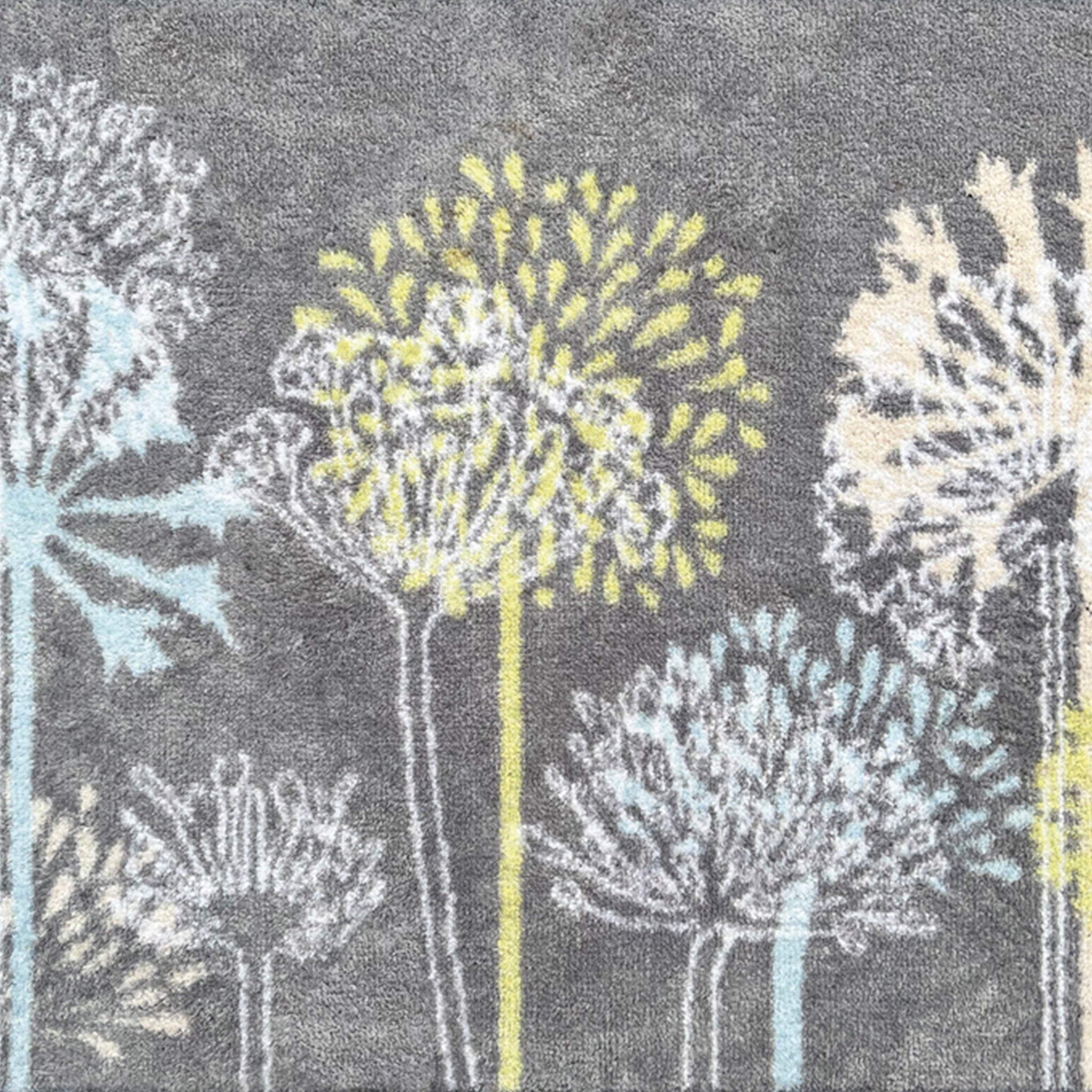 Nature 17 Dandelions Grey Runner- a 100% recycled cotton runner featuring a horizontal row of dandelions in various sizes, in lime green, yellow, white, and light blue.