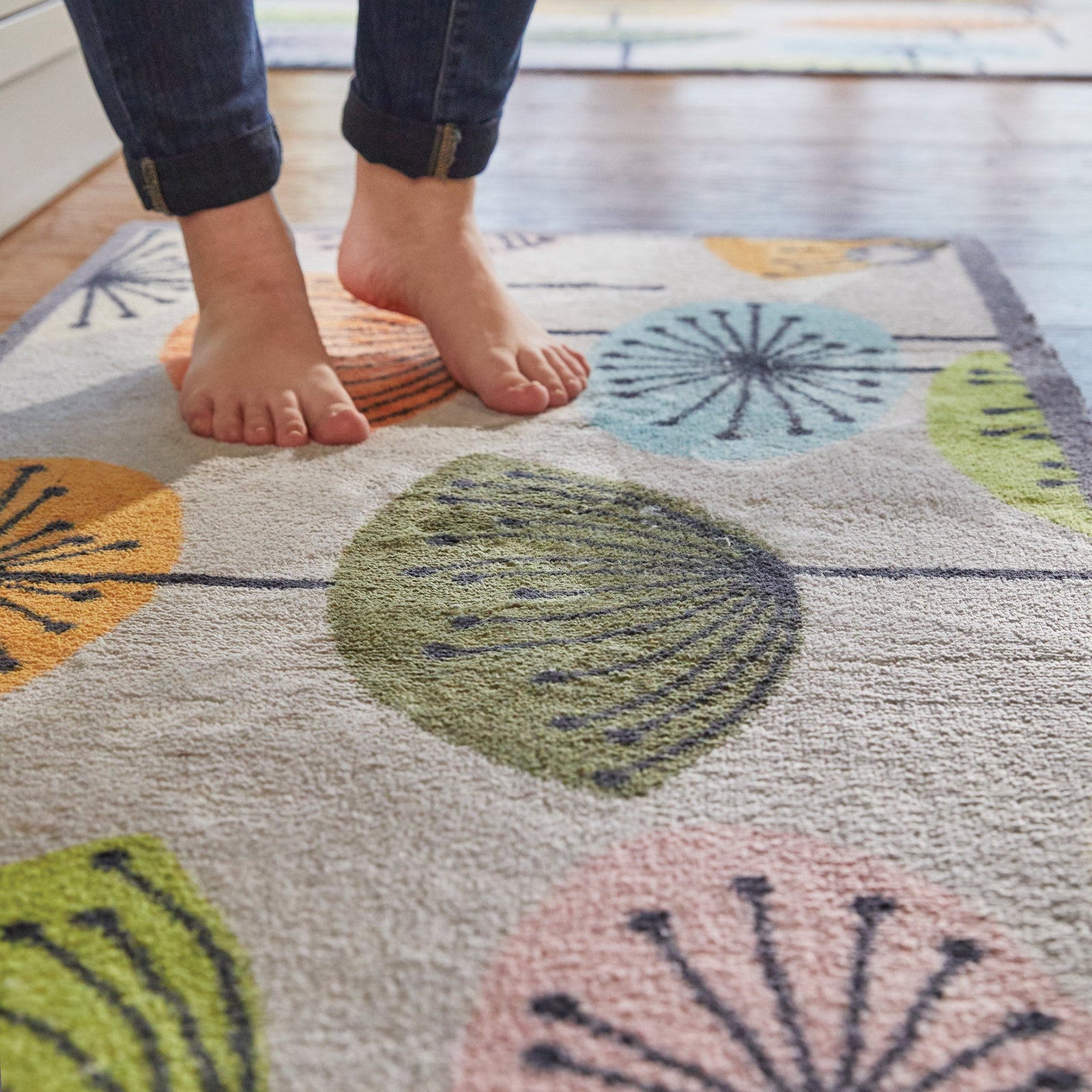 Nature 40 Washable Runner in Grey- a 100% recycled cotton runner featuring dandelions in blue, orange, green, khaki, pink, and cream.