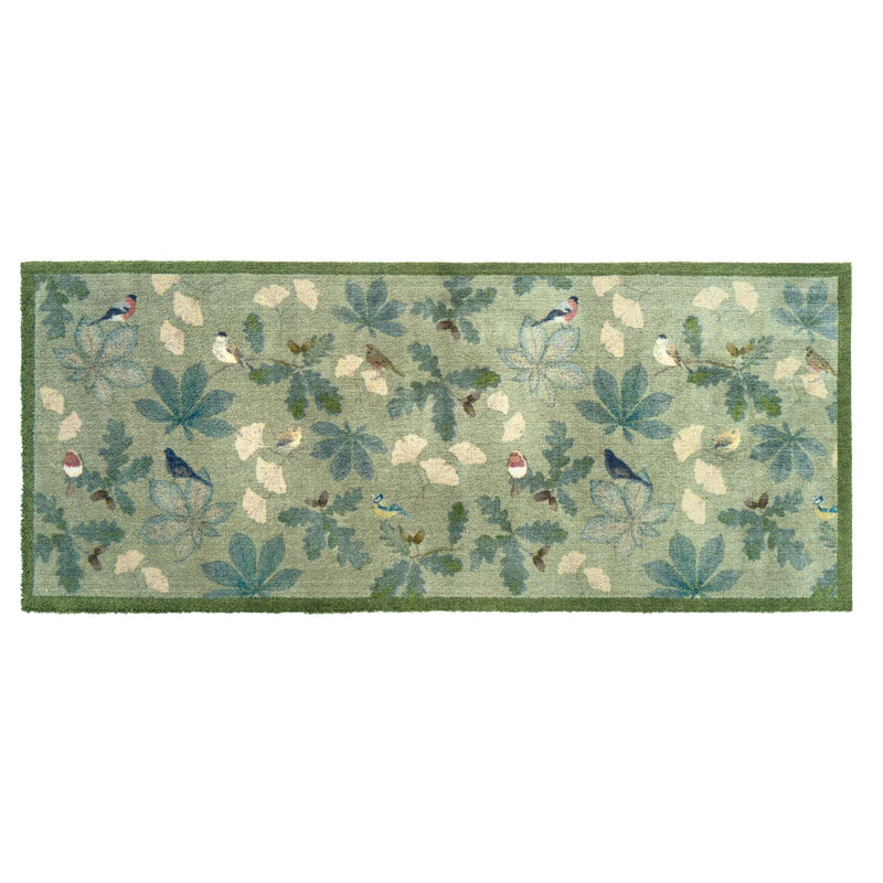 A rectangular area runner with a woodland pattern featuring blue birds, green leaves, and cream-colored acorns on a sage green background, finished with a solid green border.
