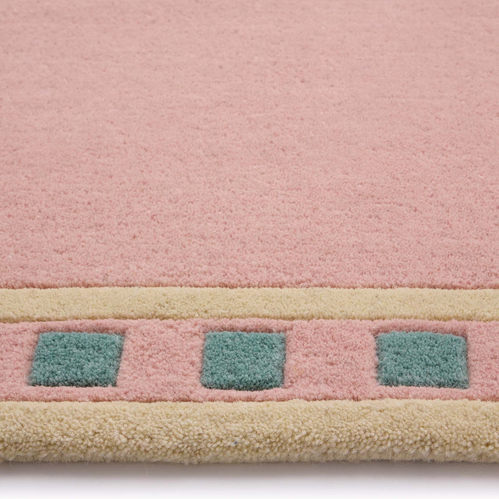 Borderline Pink Rug- 100% wool cut pile rug with a geometric patterned border. 