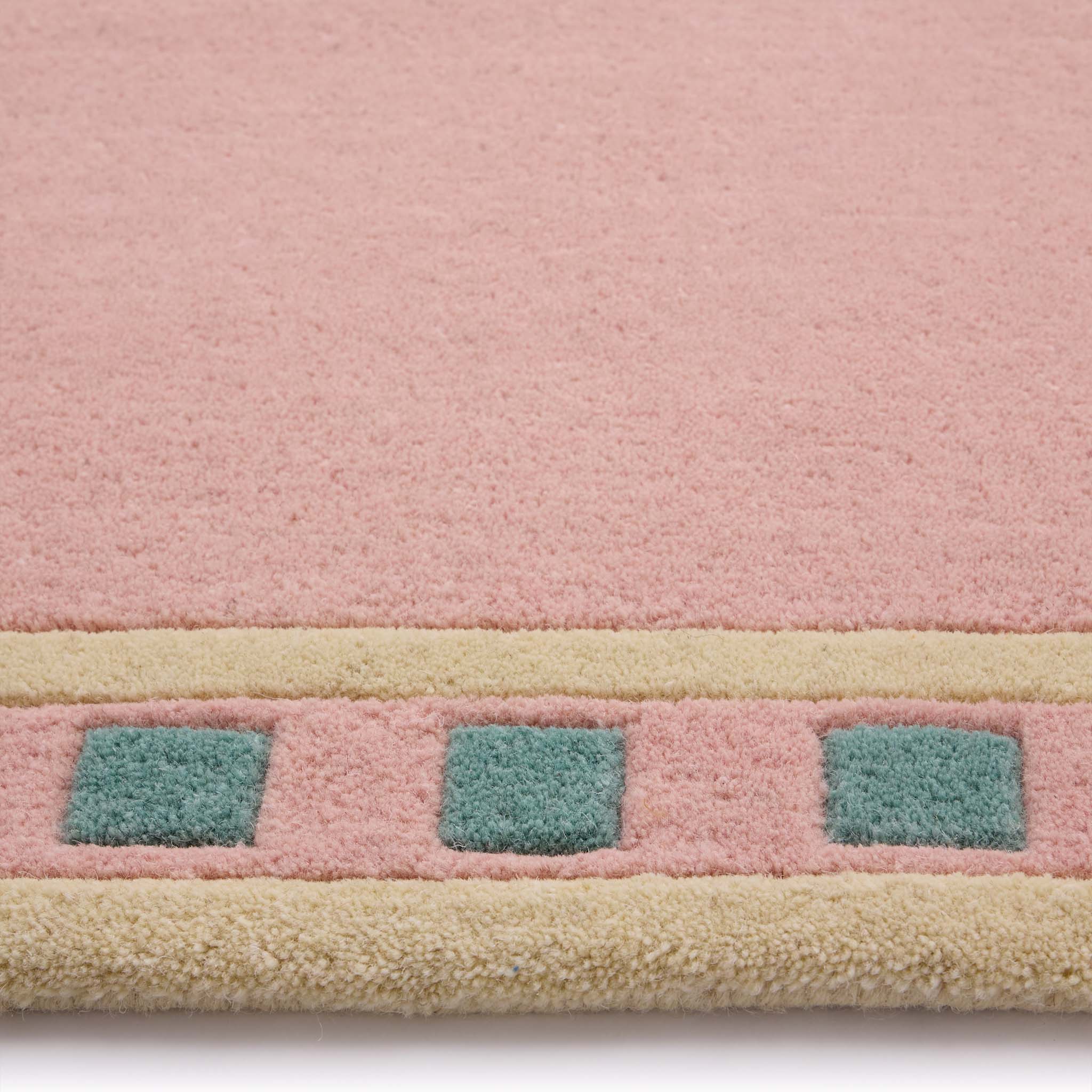 Borderline Pink Rug- 100% wool cut pile rug with a geometric patterned border. 