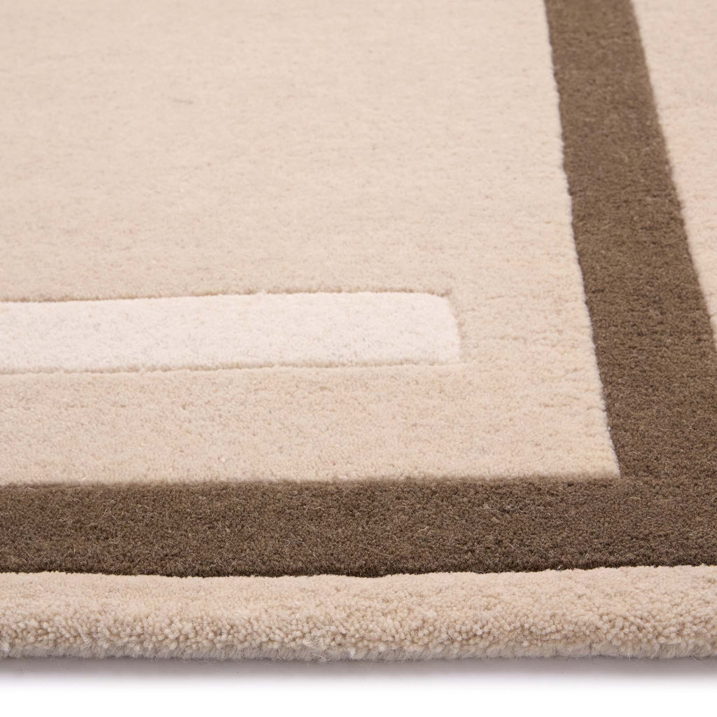 Contour Rug- a 100% wool carved rug featuring a cream and brown border.