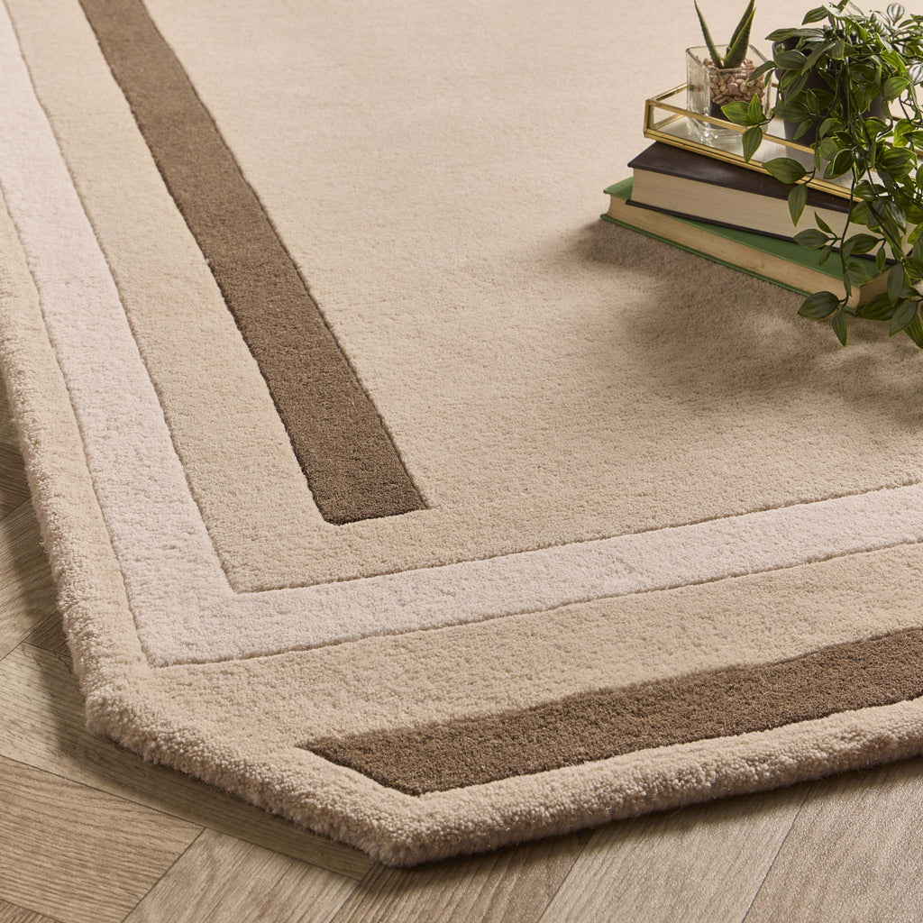 Contour Rug- a 100% wool carved rug featuring a cream and brown border.