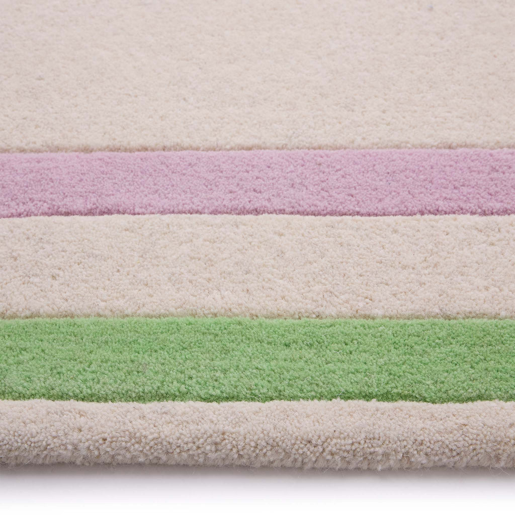 Contour Lavender Green Rug- a 100% wool carved rug featuring a lavender and green border. 