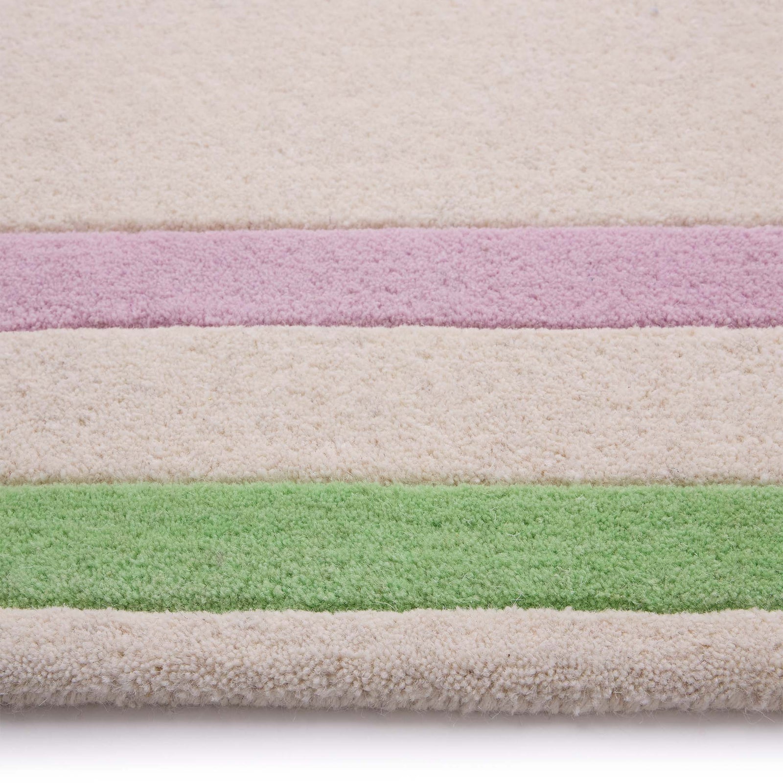 Contour Lavender Green Rug- a 100% wool carved rug featuring a lavender and green border. 