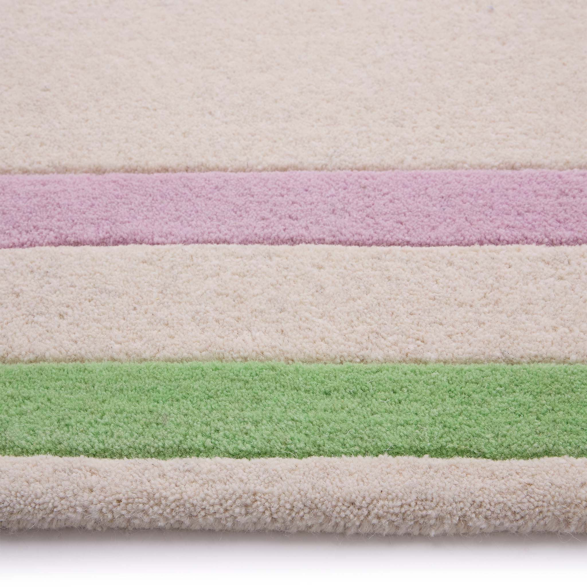 Contour Lavender Green Rug- a 100% wool carved rug featuring a lavender and green border. 