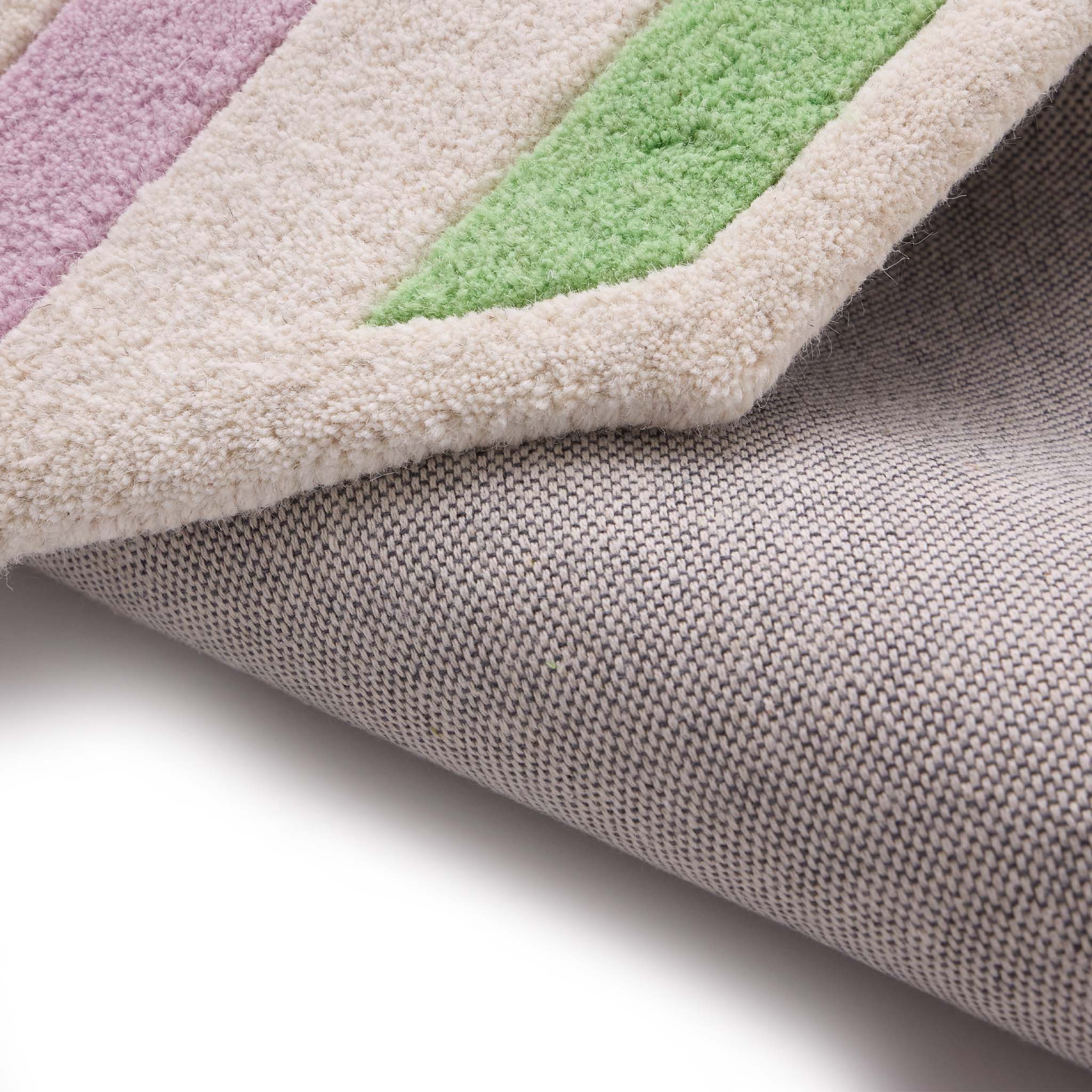 Contour Lavender Green Rug- a 100% wool carved rug featuring a lavender and green border. 