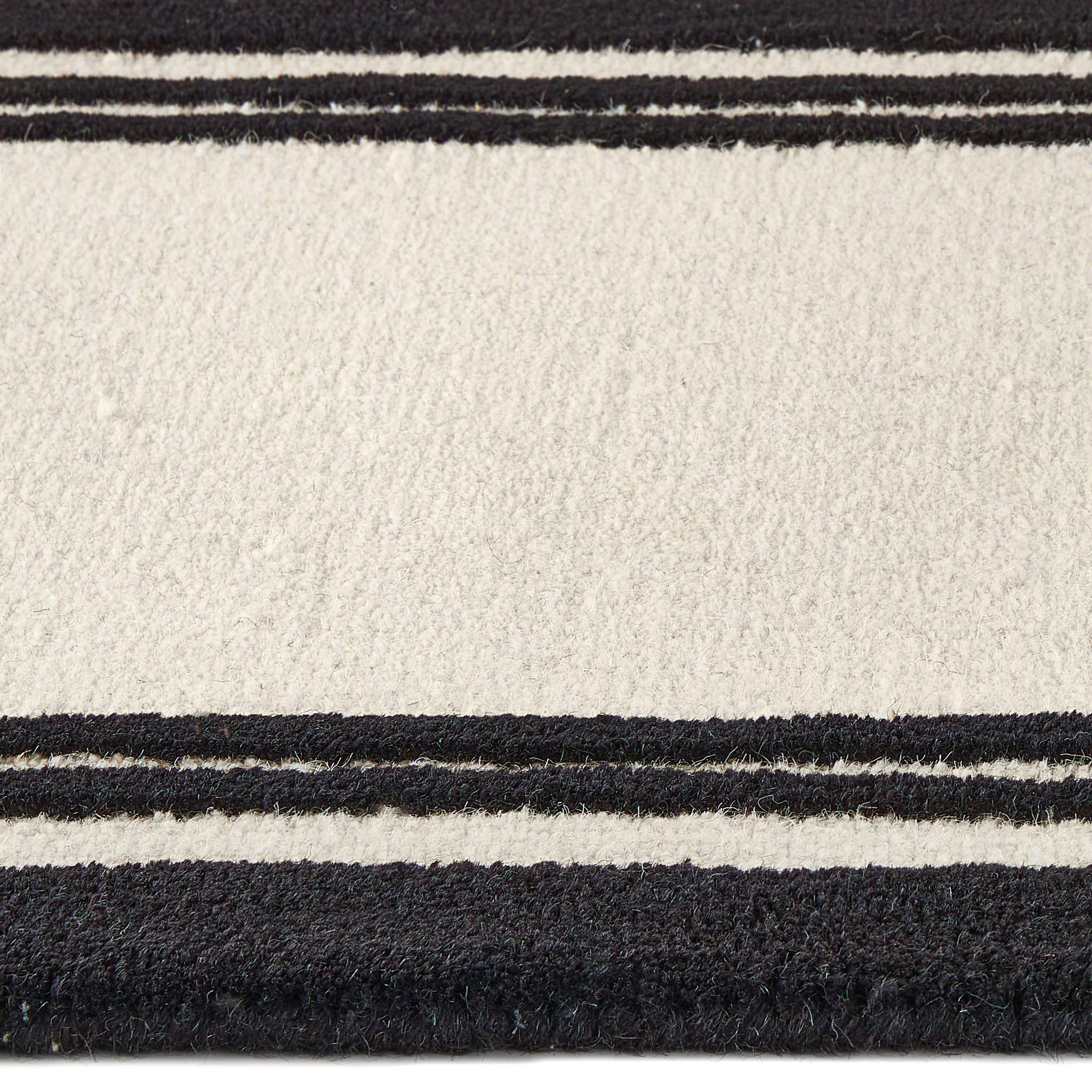 Close up of Piper Monochrome Wool Runner showing pile height and  black two border design.