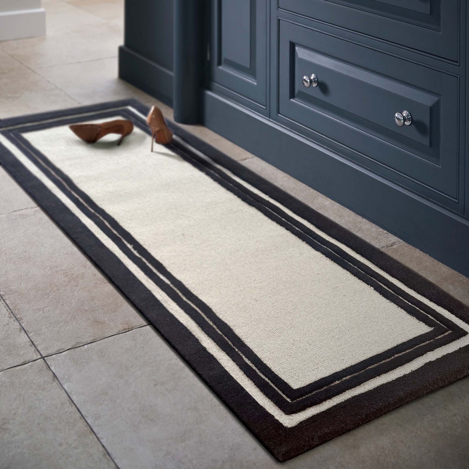 Piper Monochrome Wool Runner with a black two border design, styled in a entryway.