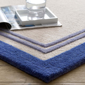 Piper Rug Navy- 100% wool rug with a purple and blue border.