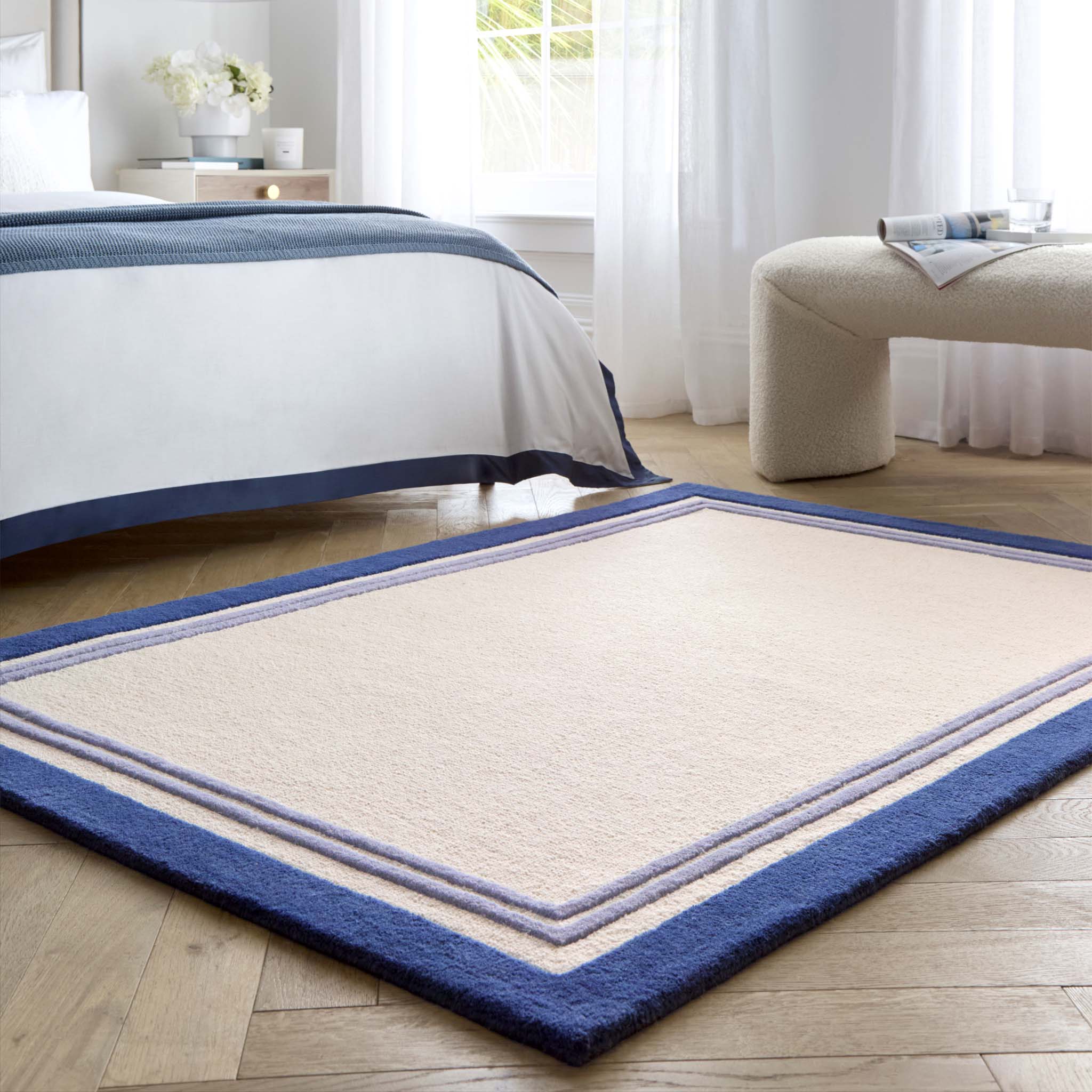Piper Rug Navy- 100% wool rug with a purple and blue border.