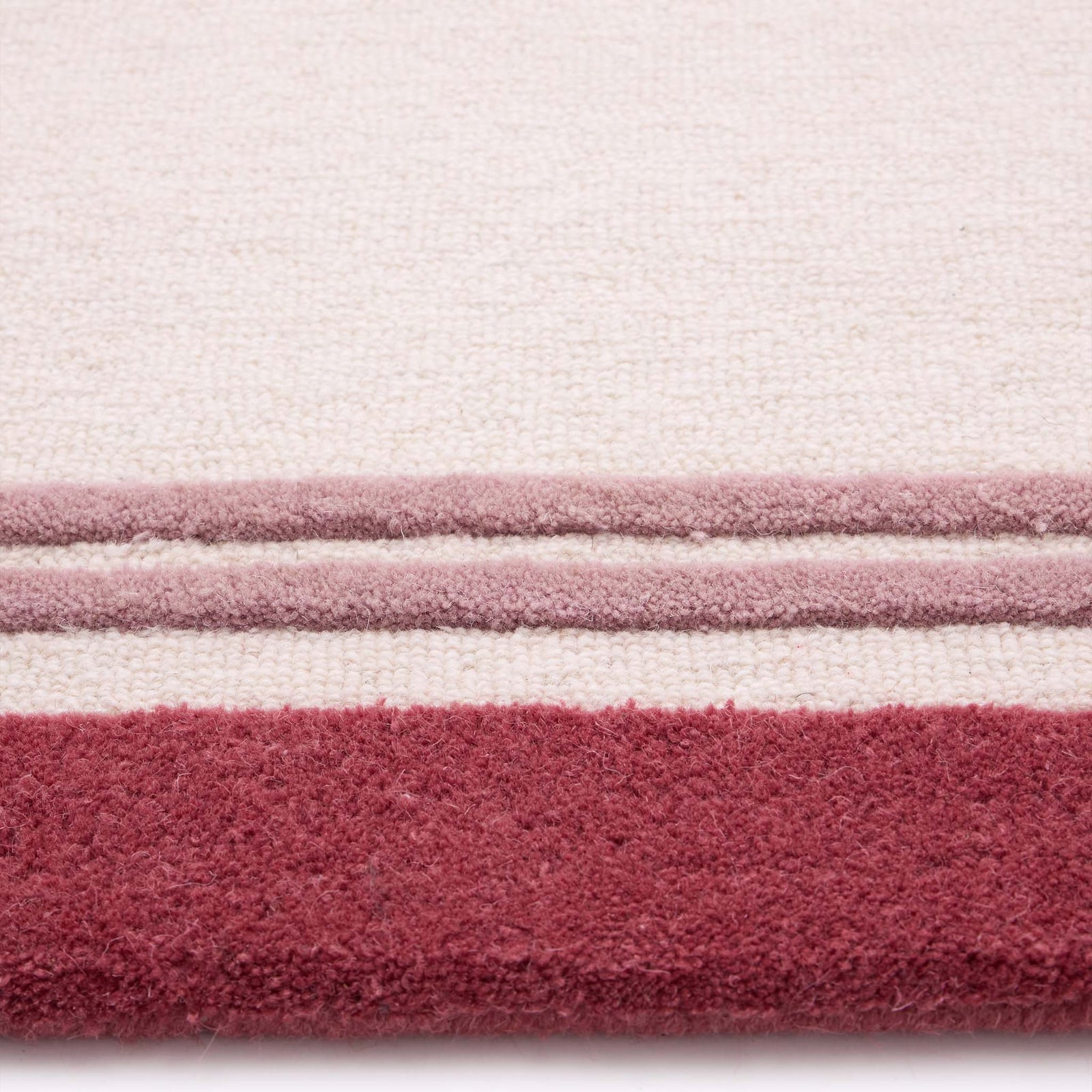 Piper Rug Runner Raspberry- a 100% wool runner featuring a pink border.