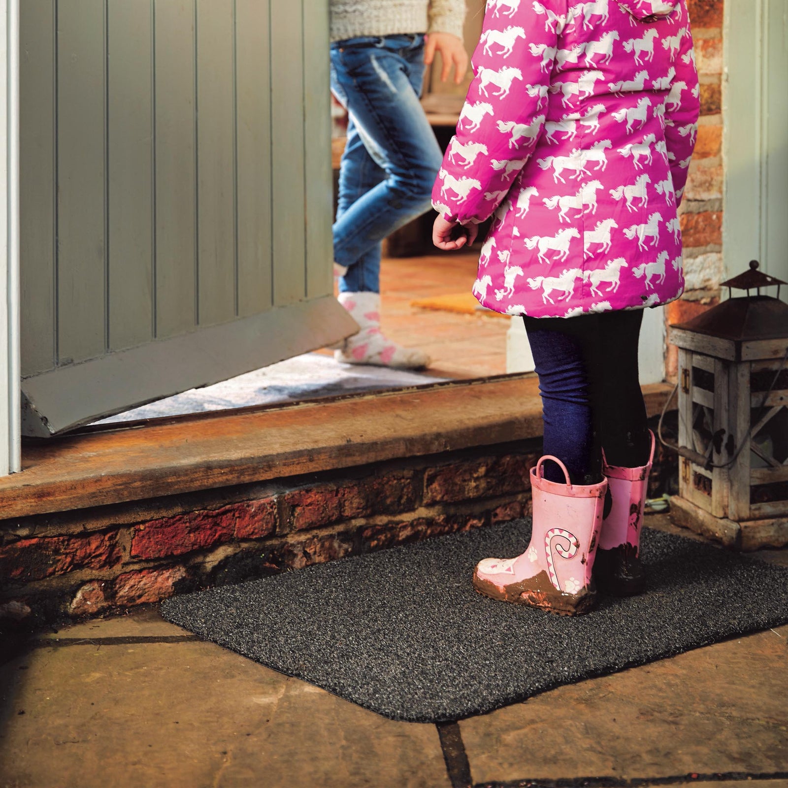 Outdoor Charcoal Doormat made from recycled material, styled in a doorway.