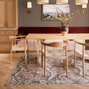 Paisley Tapestry Smoke Eco-Washable Rug with a paisley pattern, styled under a dining room table.