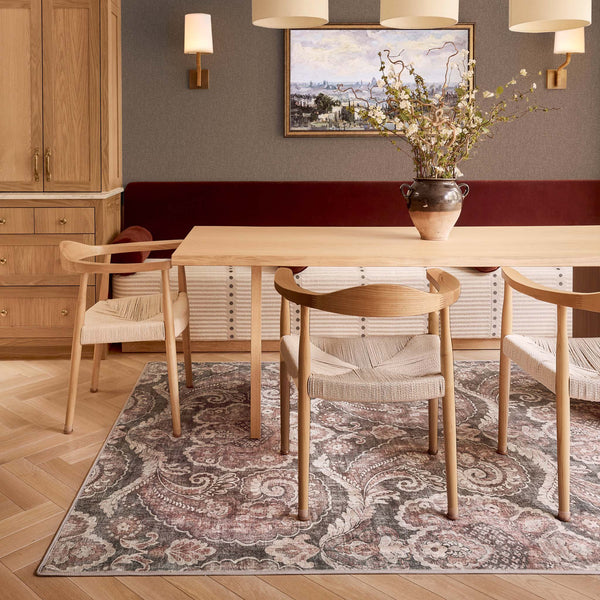Paisley Tapestry Smoke Eco-Washable Rug with a paisley pattern, styled under a dining room table.