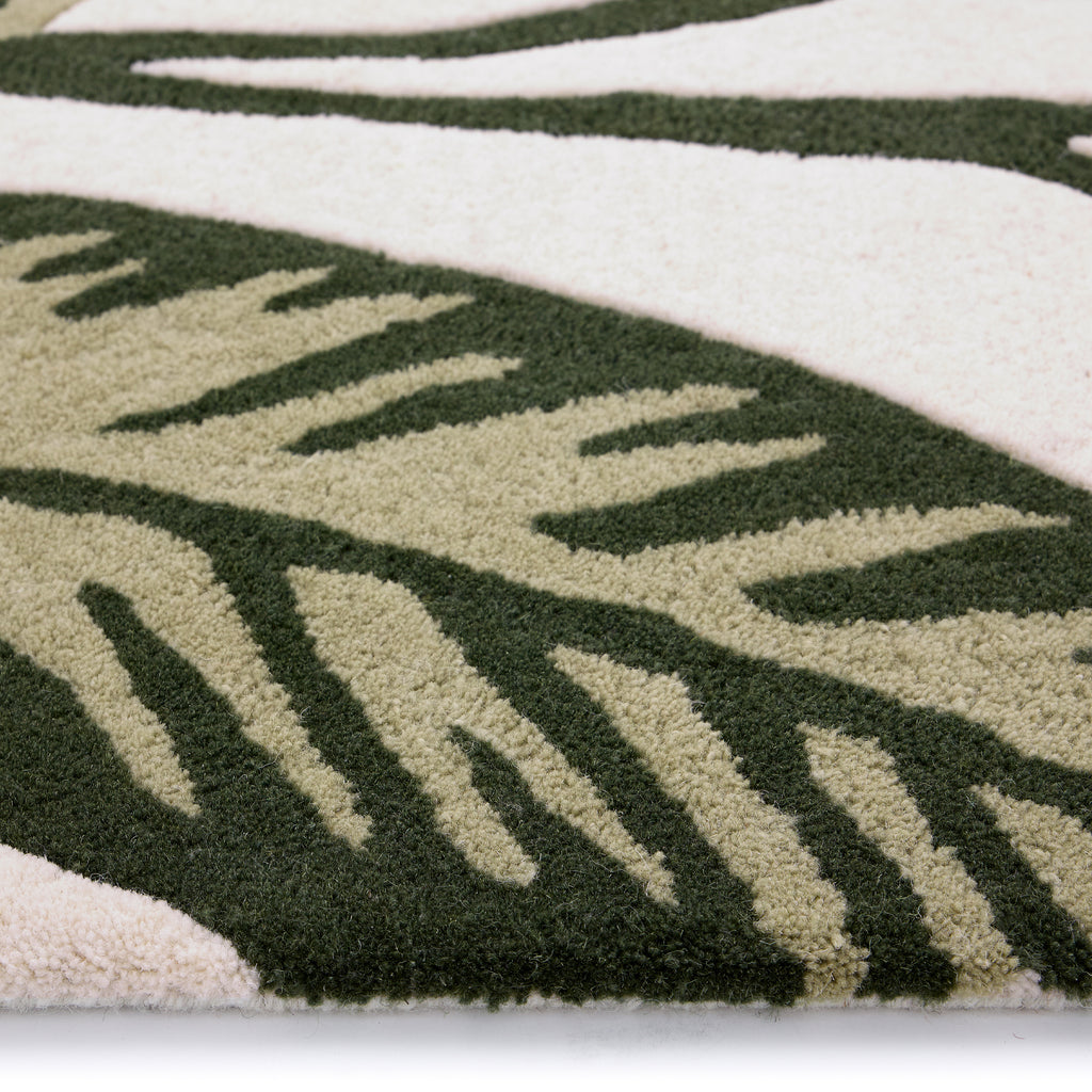 Discover the Paradise Leaf Rug- 100% wool cut pile rug in cream with a leaf design. 