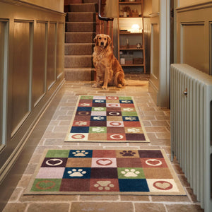 Hug Rug Tartan Paw Green Doormat and Runner with a check pattern with hearts and paw prints, styled in a entryway.