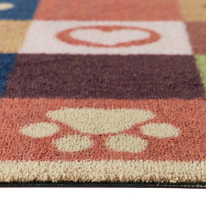 Close-up of a colorful textured runner with a cream paw print motif on a terracotta background and a white heart on an orange block.