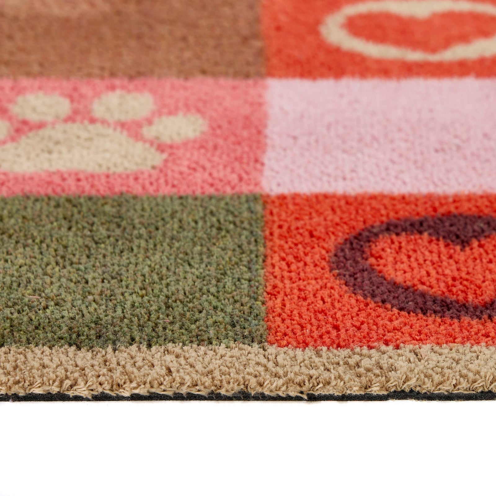 Patchwork Paws Washable Runner- a 100% recycled cotton runner featuring colourful squares decorated with paw prints and hearts in shades of red, purple, pink, green, and brown.