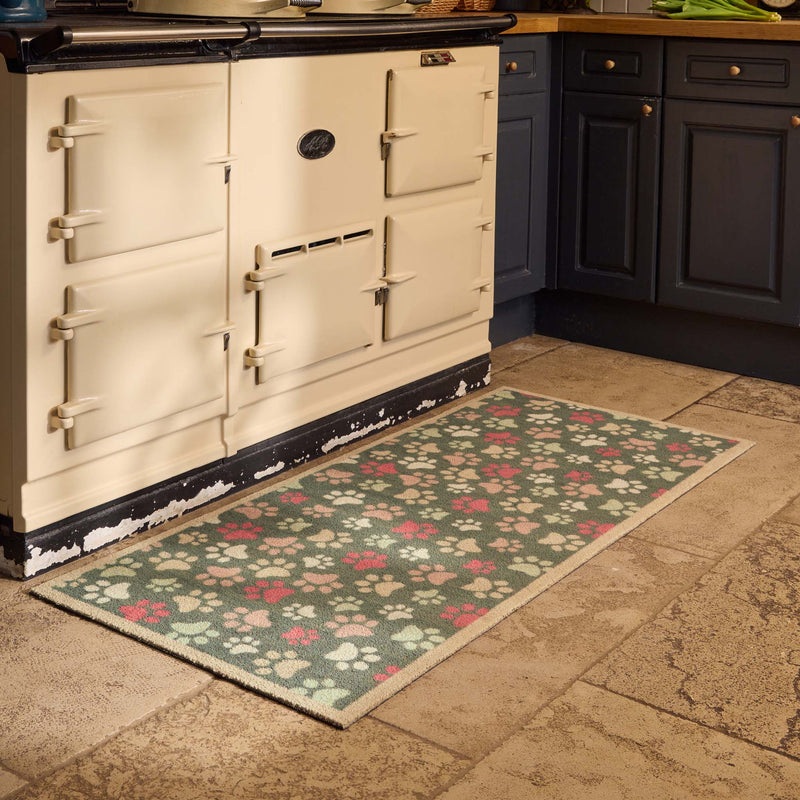 Paws For Love Green Washable Runner with a paw print design, styled in a kitchen.