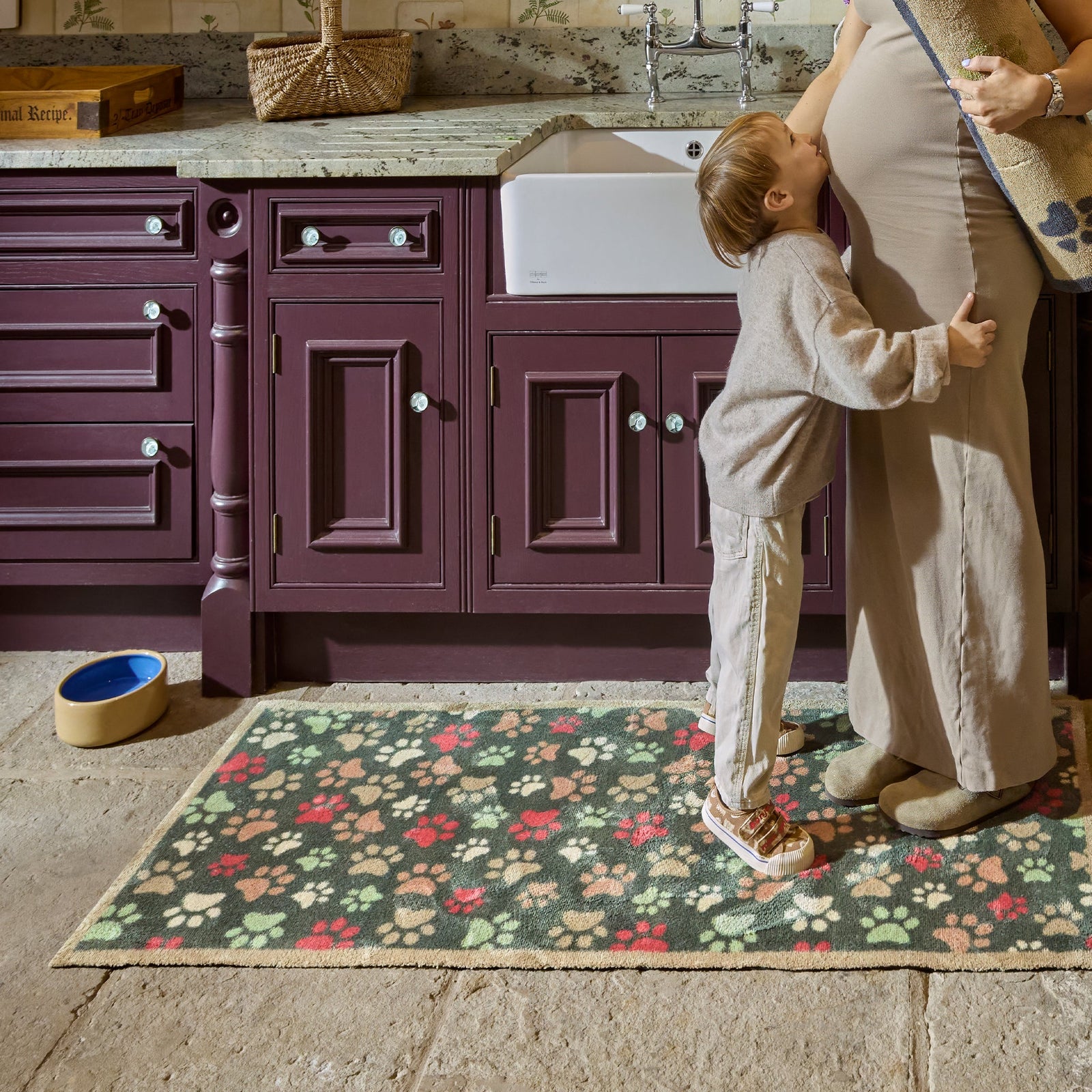  Paws for Love Washable Runner in Green- a 100% recycled cotton runner featuring multi-coloured paw prints in a multi-directional pattern.