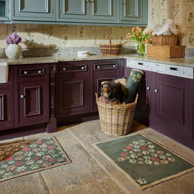 Paws For Love Green Washable Doormat with a paw print love heart design, styled in a kitchen. 
