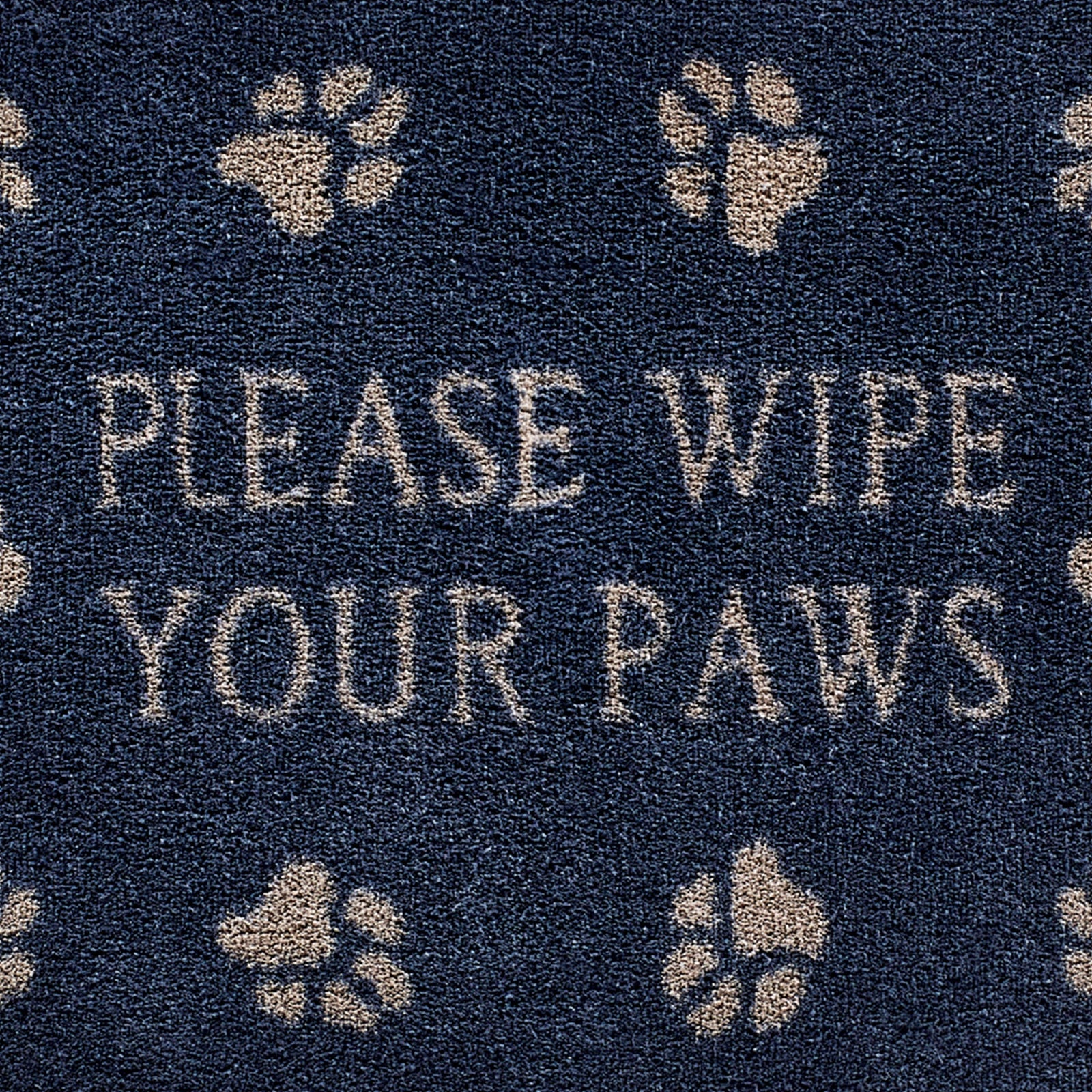 Close up image of the please wipe your paws text and pattern on a navy Pet 10 washable doormat from Hug Rug