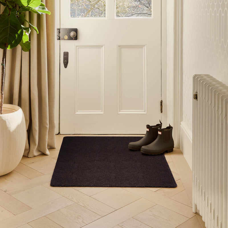 Plain Fleck Espresso Brown Doormat with a brown fleck design, styled in a doorway.