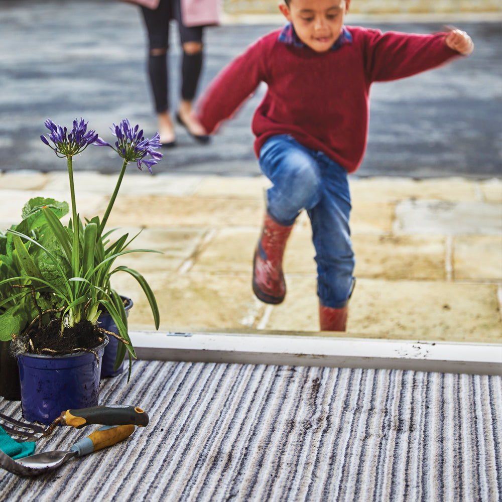 Candy Portland Stripe Washable Doormat made from 100% recycled materials, featuring a subtle striped pattern.