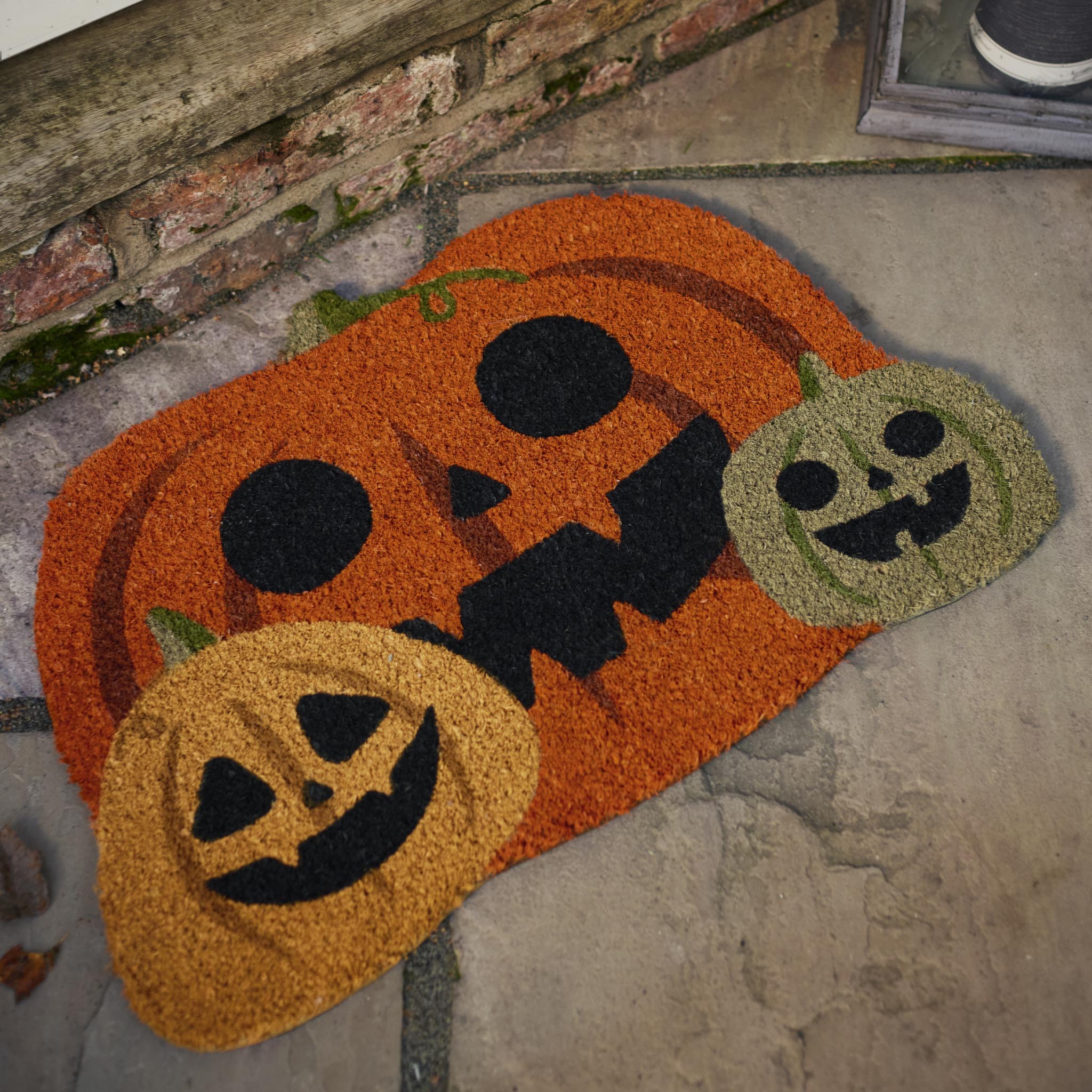 Discover the Pumpkin Halloween Coir Doormat in Orange- a coir doormat with a graphic pumpkin design. 