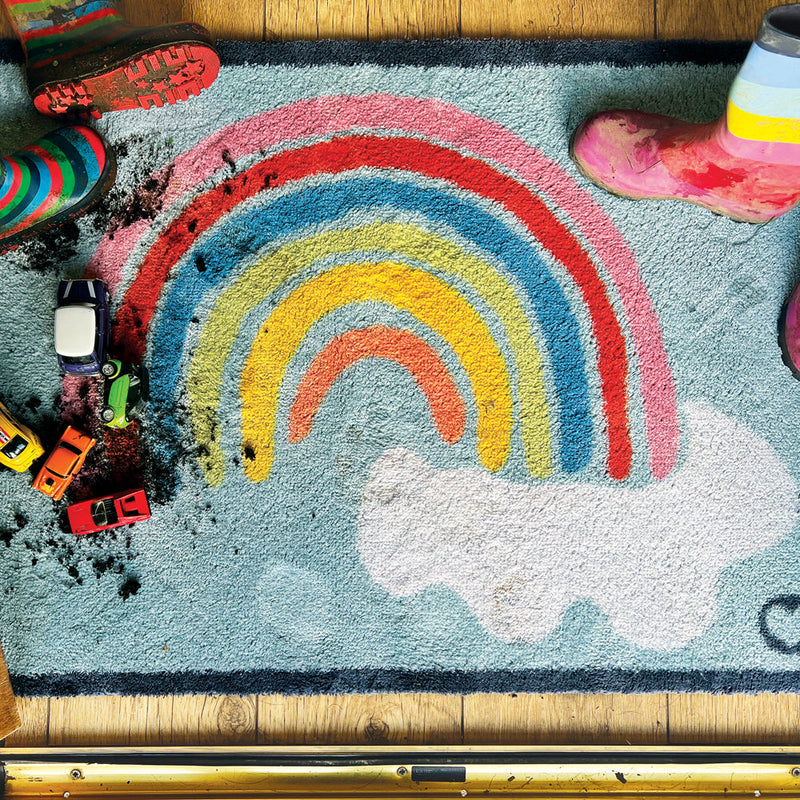 Rainbow 2 Charity Doormat- a 100% cotton doormat in sky blue featuring a rainbow and clouds design. 