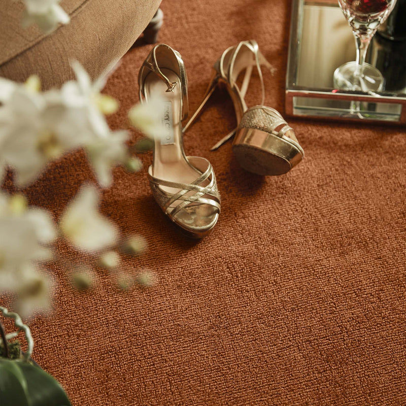 Reef Rust Rug - a 100% recycled material rug featuring an orange/red textured pattern.