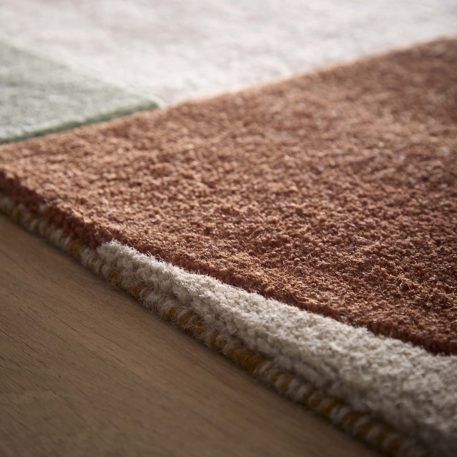 Close-up of Retro Deco Tan Wool Rug showing pile height and carved geometic details. 