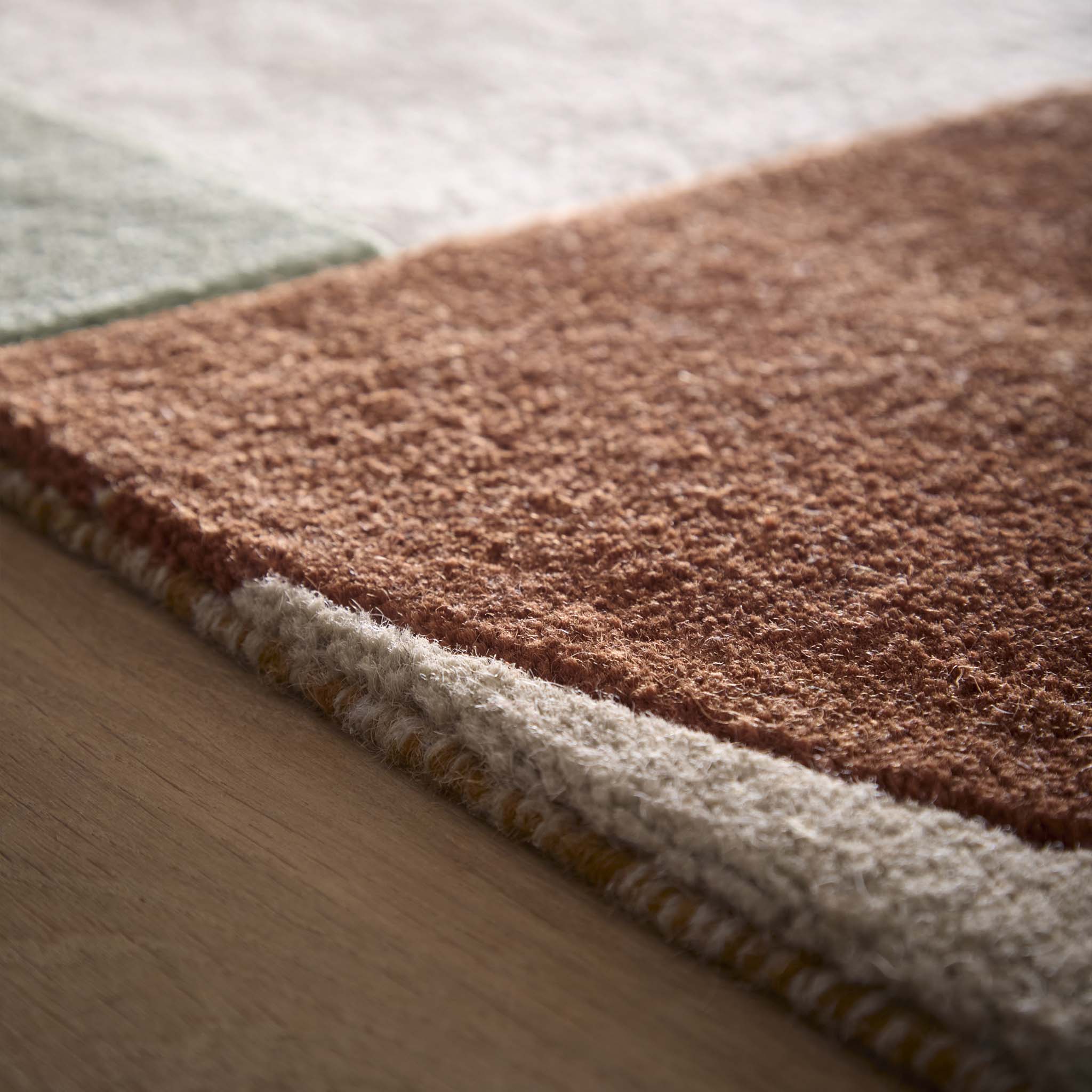 Close-up of Retro Deco Tan Wool Rug showing pile height and carved geometic details. 