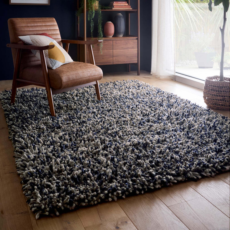 Rocks Shaggy Navy Rug - a 100% wool dark blue rug featuring a shaggy fleck pattern.