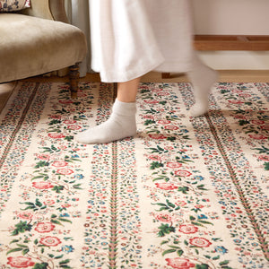 Close-up of Rose Pergola Chintz Eco-Washable Rug with a floral design.